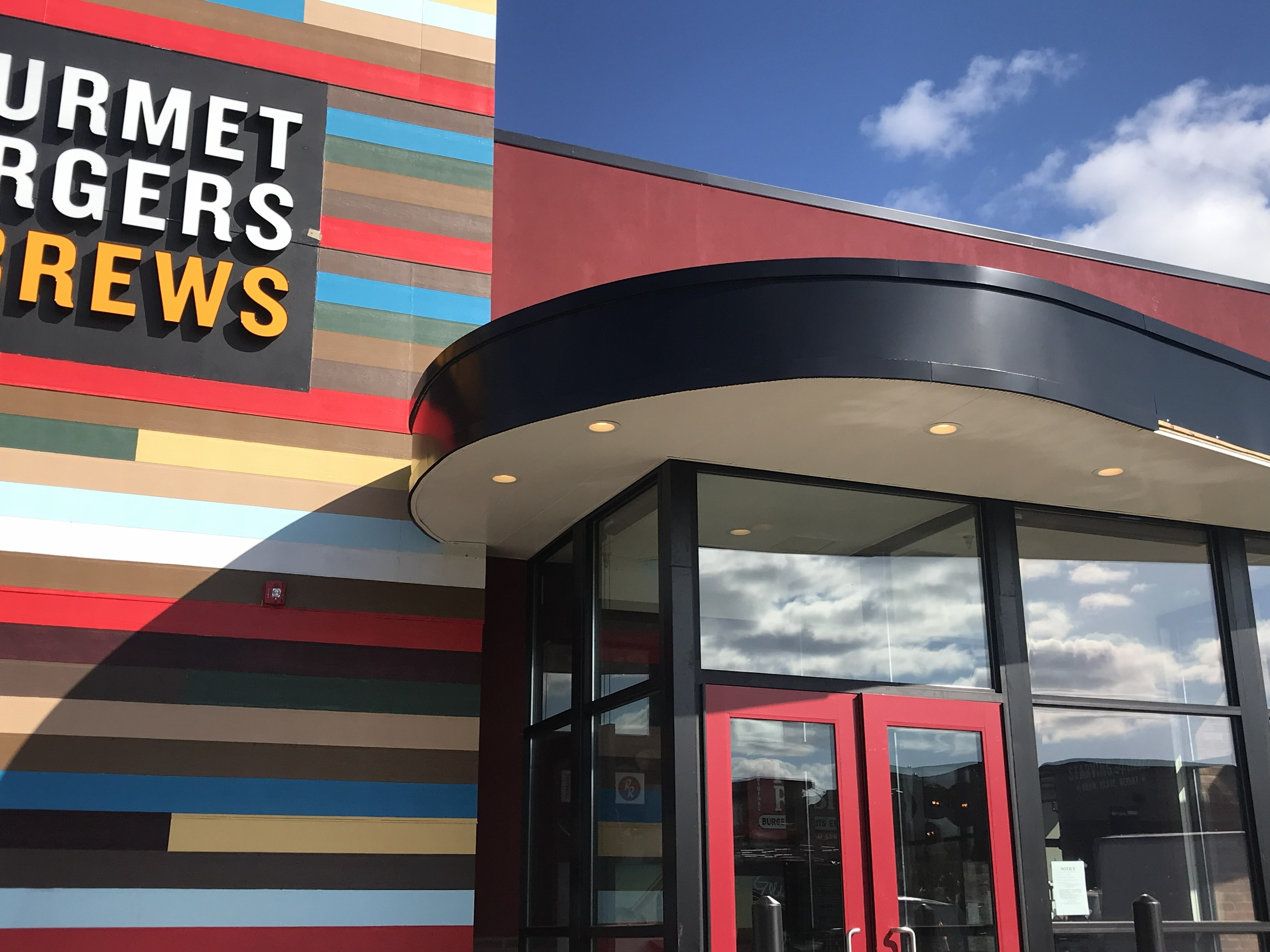 Black metal siding and roofing installation detail in Ware MA